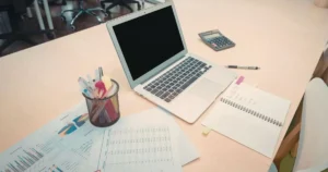 Workspace with computer and documents illustrating the role of AI in modern SEO