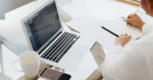 Hands typing on a laptop illustrating intentional marketing and qualified inquiries